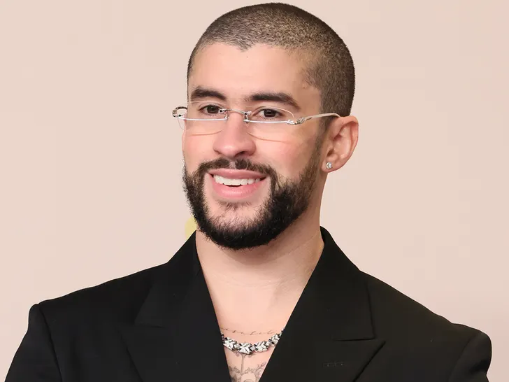 Bad Bunny holding Latin Artist of the 21st Century award on stage